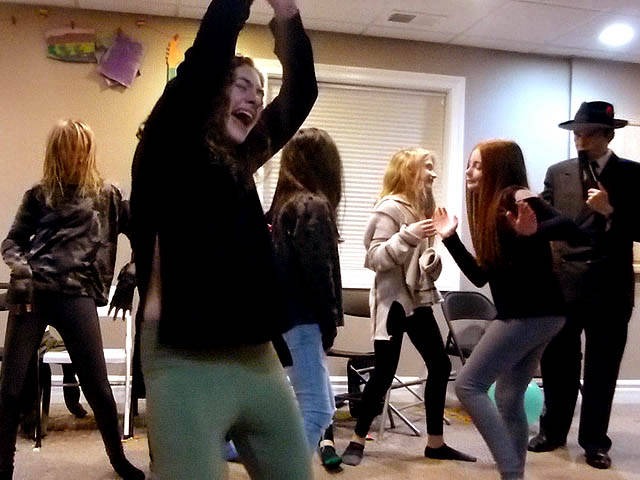 Tween girls dance at a Chicago area home  hypnosis show.